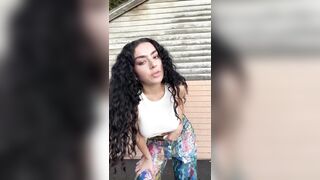 charli xcx -  A brunette wearing clothes dances in front of the camera